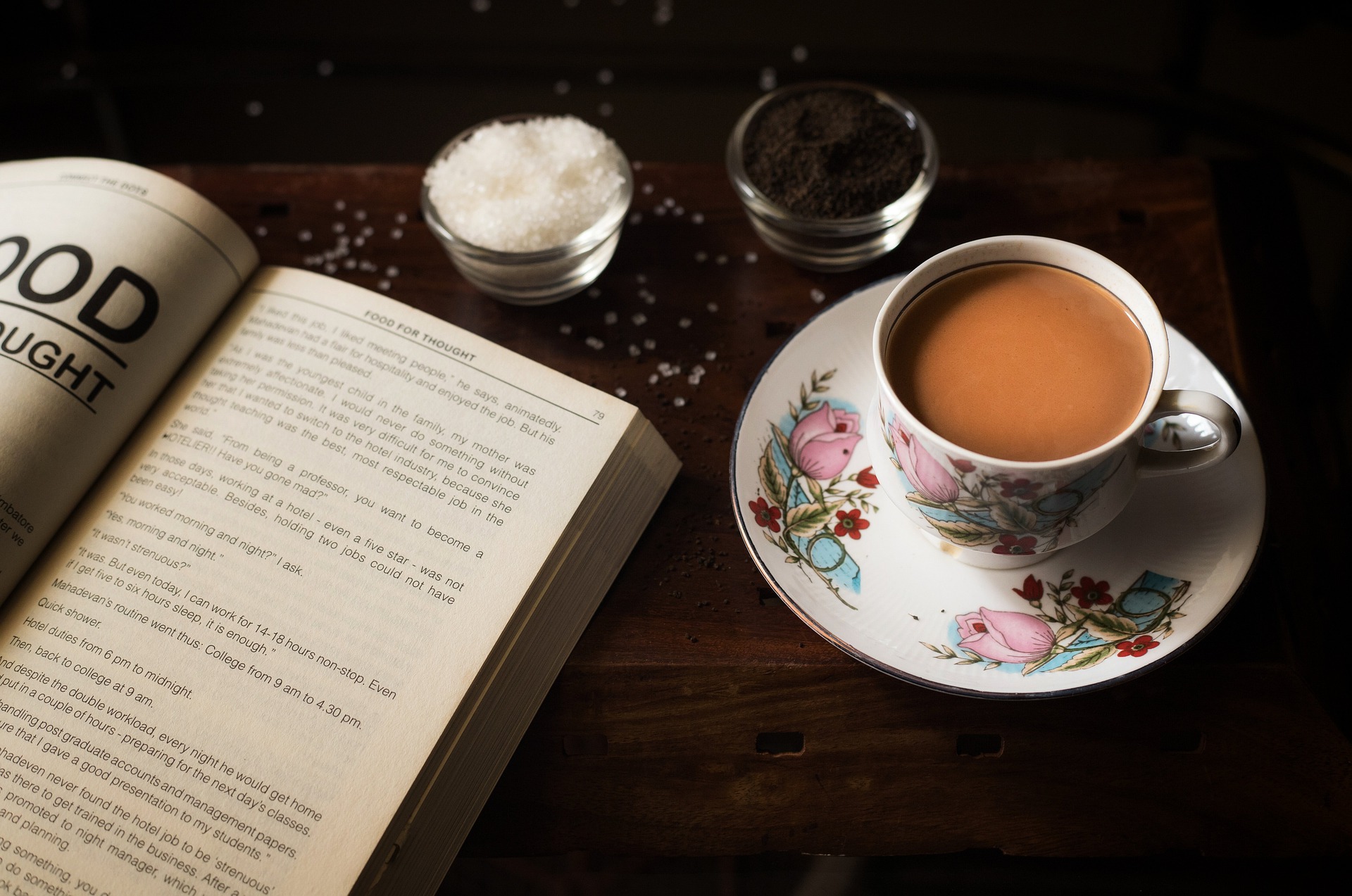 Book and cup of coffee with sugar